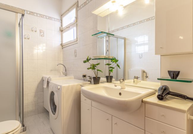 bathroom with shower and washing machine bathroom with shower and washing machine