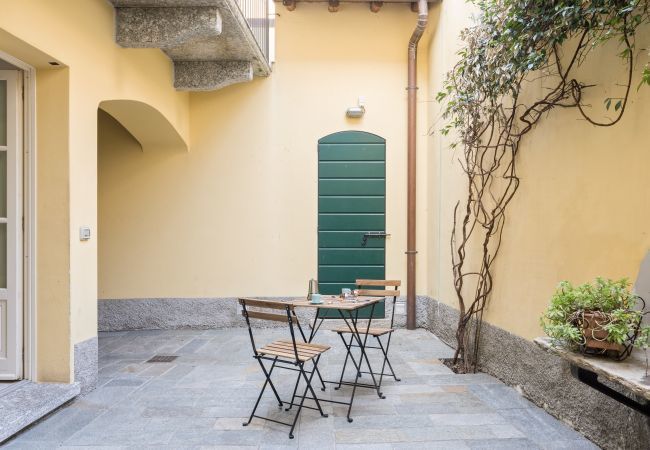 Spacious and bright outdoor area immersed in tranquillity Private garden with wooden table